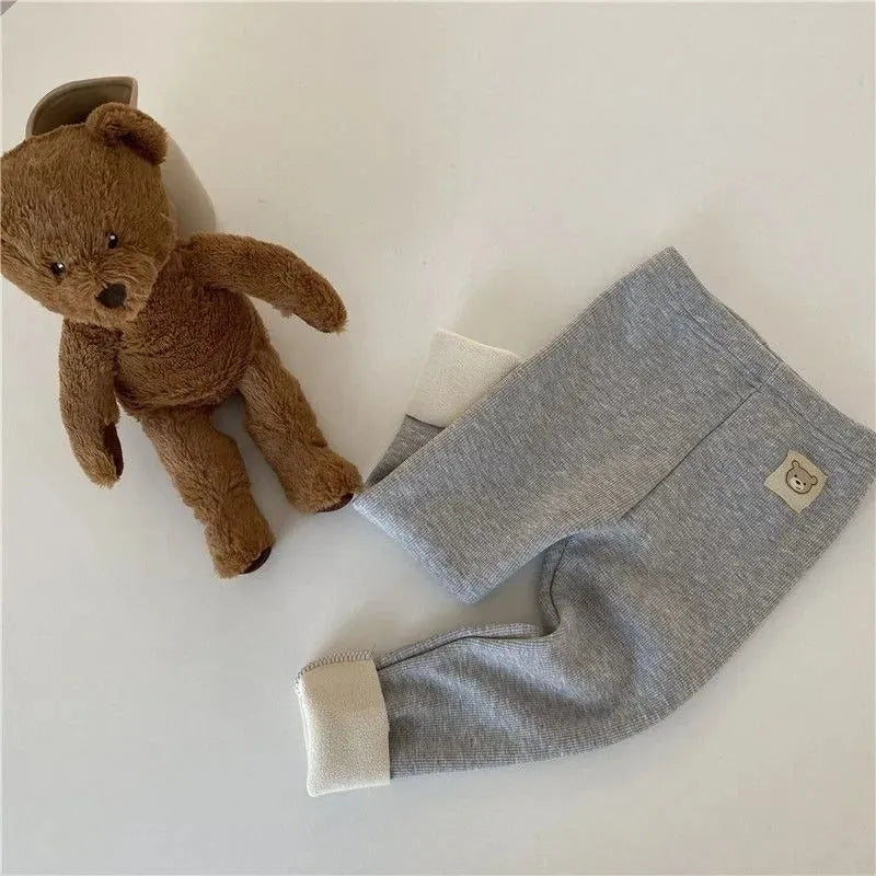 Girls solid colour fleece-lined leggings with high waist and hair band belt, shown in beige, black, brown, grey.