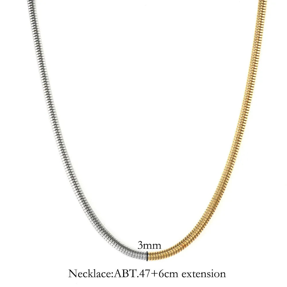 Close-up of a women's golden snake bones chain necklace with geometric lines, 3mm wide.