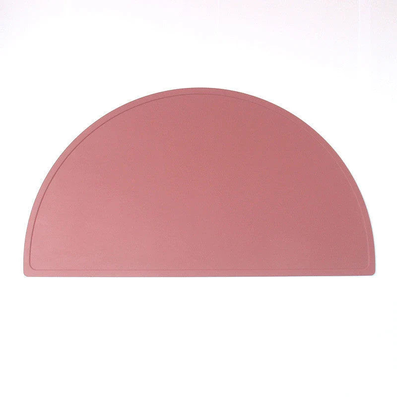 A durable, food-grade silicone placemat in various colours, suitable for Kiwi kids' mealtimes.