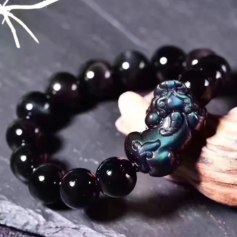 Natural Ice Obsidian beaded bracelet on wrist showing pale crystal beads.