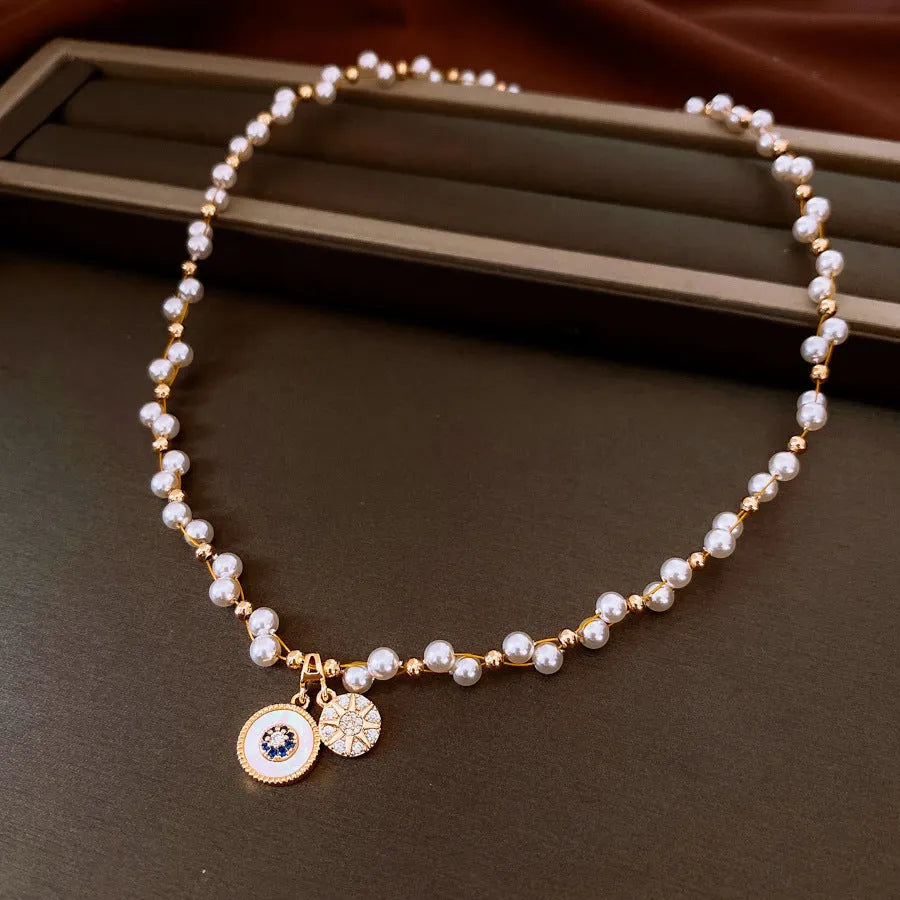 Gold electroplated necklace with white round pearl pendant on clavicle chain