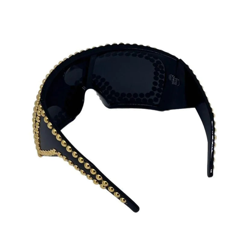 Men's punk-style sunglasses with large square silver frames and prominent rivet details.