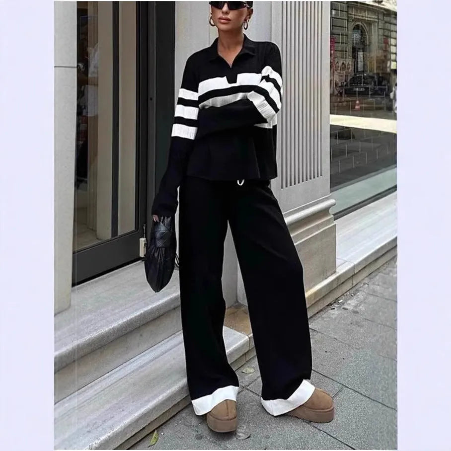 Women's black and white striped knitted polo shirt with matching trousers, a casual two-piece set.