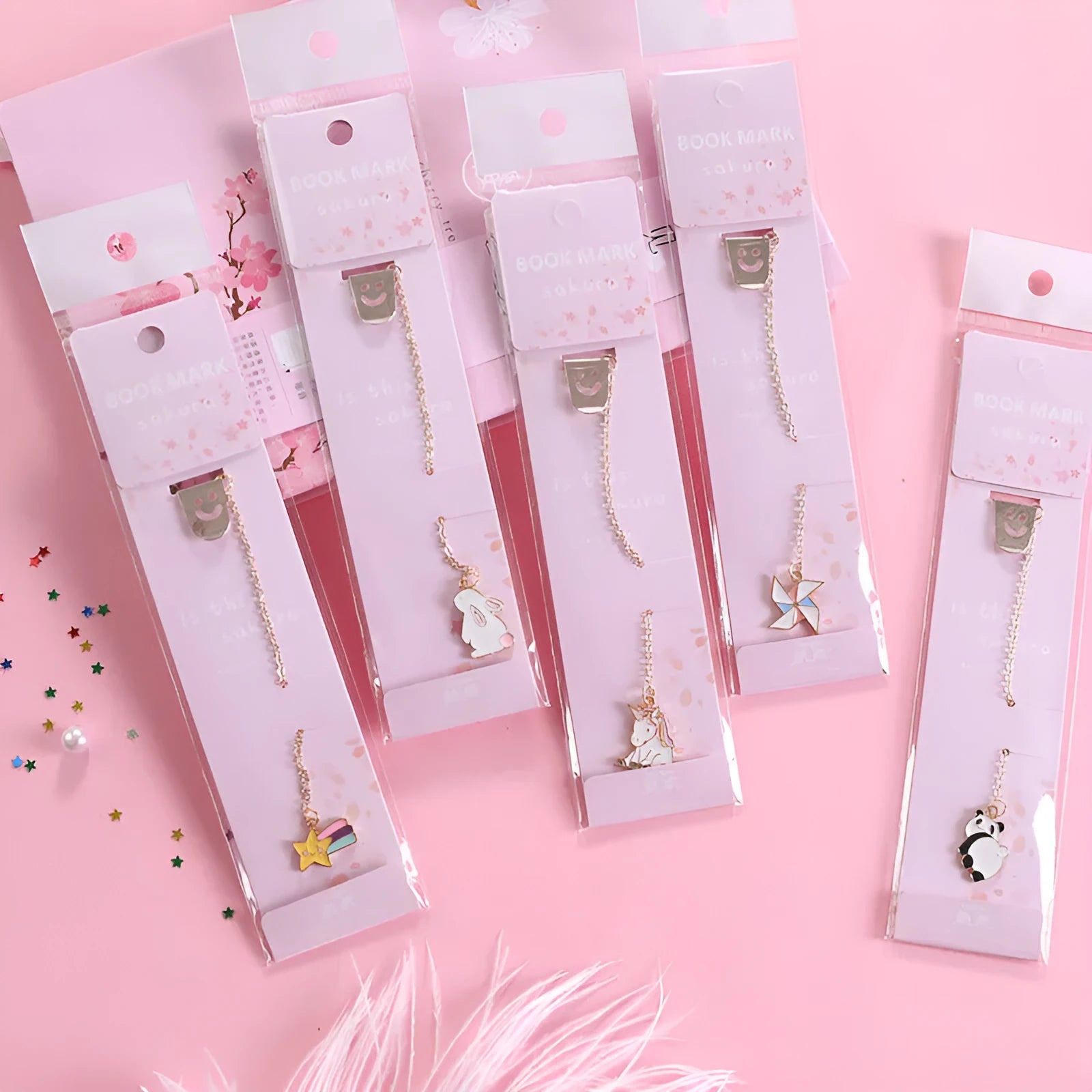 Colourful metal bookmark with a small cartoon pendant charm, showing panda and rocket design options.