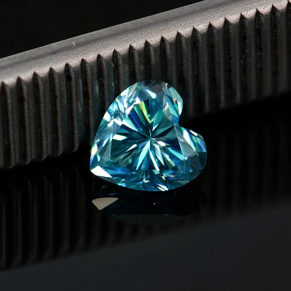 Loose heart-cut moissanite stone in lemon yellow colour on a plain background.