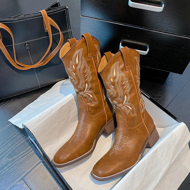 Brown leather women's mid-calf Martin boots with embroidered totem pattern and a waterproof platform sole.
