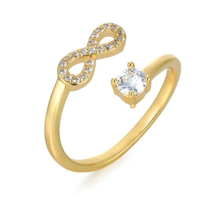 Open geometric ring with an inlaid zircon stone forming a letter, shown in gold, rose gold, and silver finishes.
