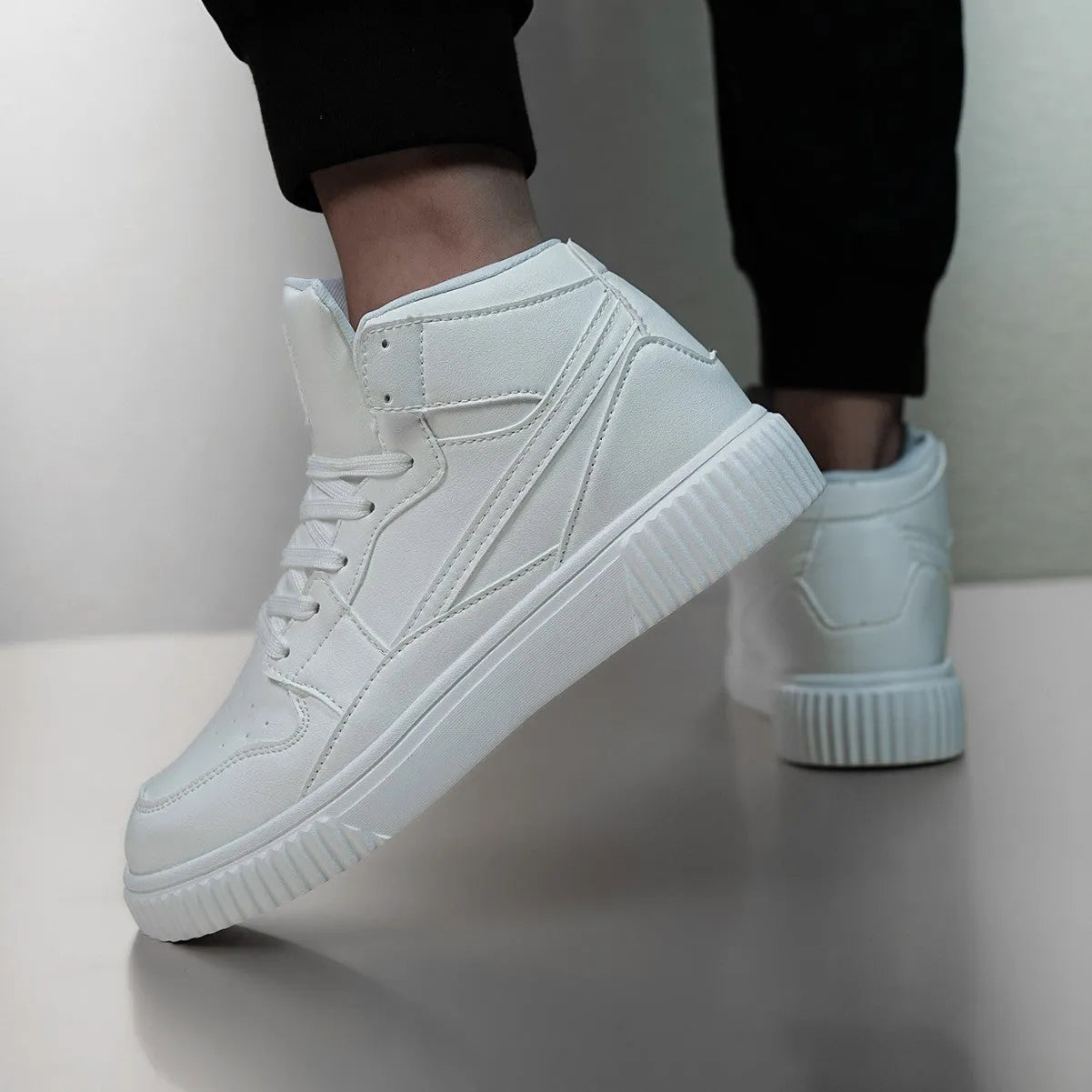White men's casual slip-on shoes with a round toe and microfiber upper on a solid background.