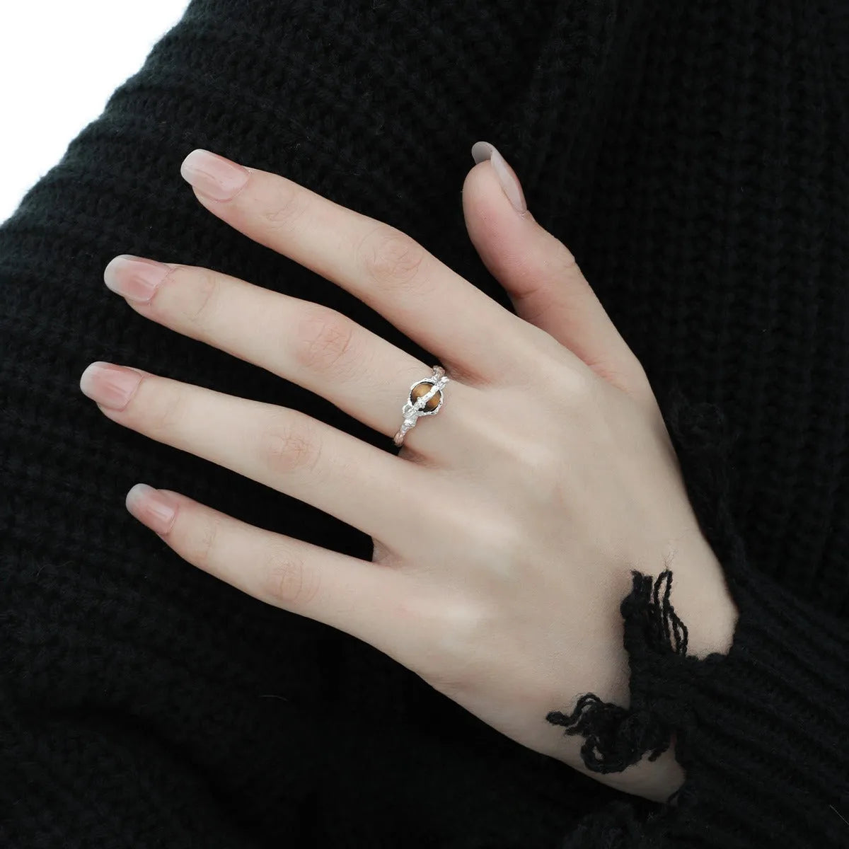 White gold colour Saturn open ring with adjustable opening on silver background