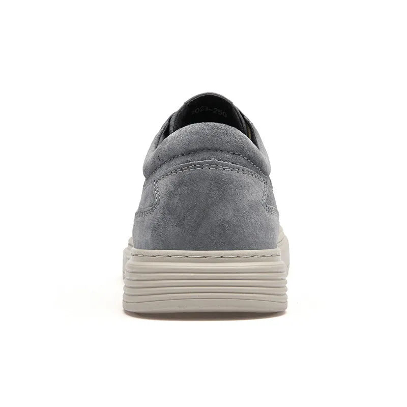 Men's grey pigskin leather low-top casual skate shoes with round toe and flat rubber sole.
