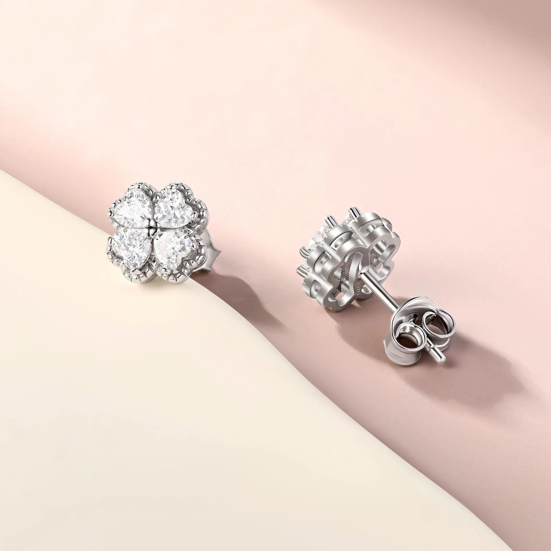 Women's sterling silver heart-shaped earrings with a four-leaf clover design and zircon stones.
