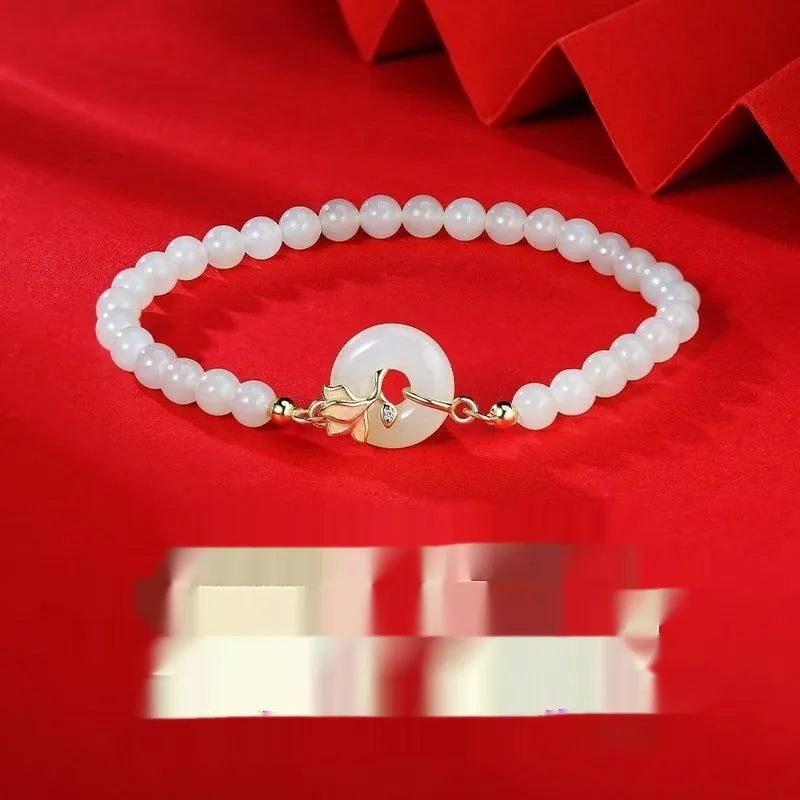 Orchid Hetian jade S925 sterling silver magnolia round beads bracelet on display