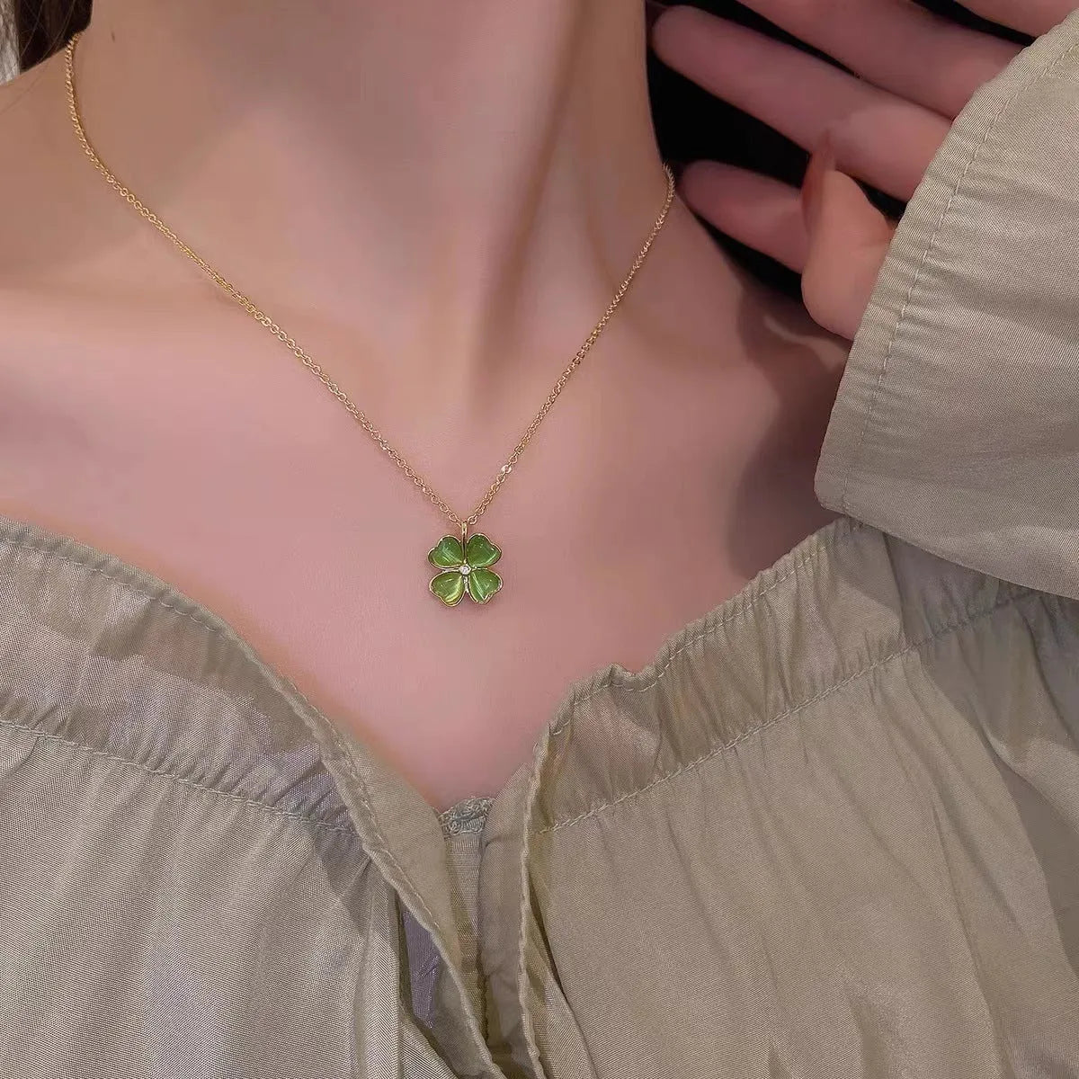 Titanium steel golden clavicle chain with geometric four-leaf flower design on unisex display