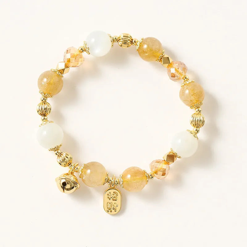 Gold electroplated adjustable chain bracelet with a rutilated quartz crystal in Lucky Fortune colour.