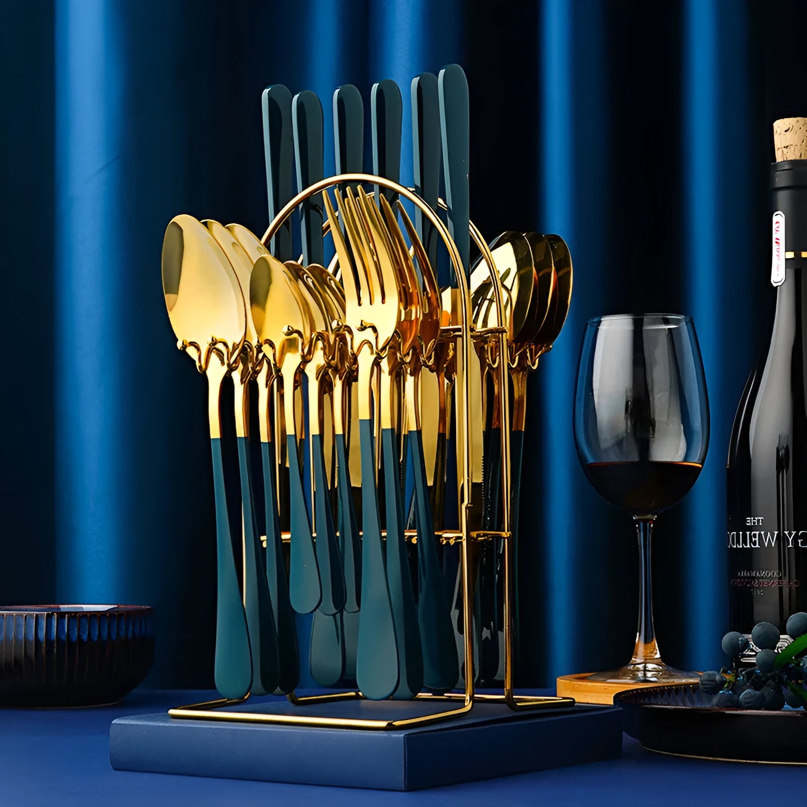 24-piece stainless steel cutlery set with storage rack in gold finish showing knives, forks, spoons