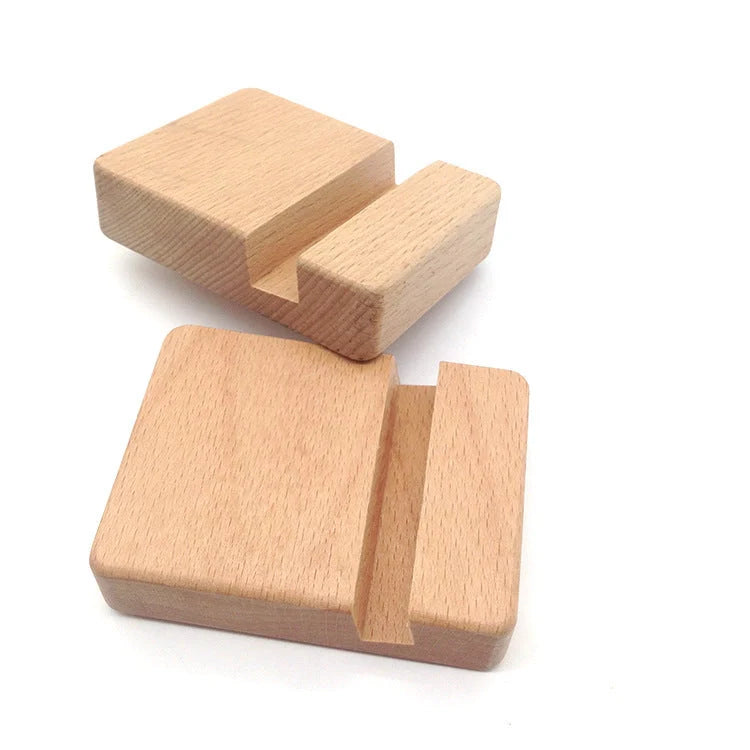 Custom lettering beech wood lazy phone holder with coin slot on a wooden table