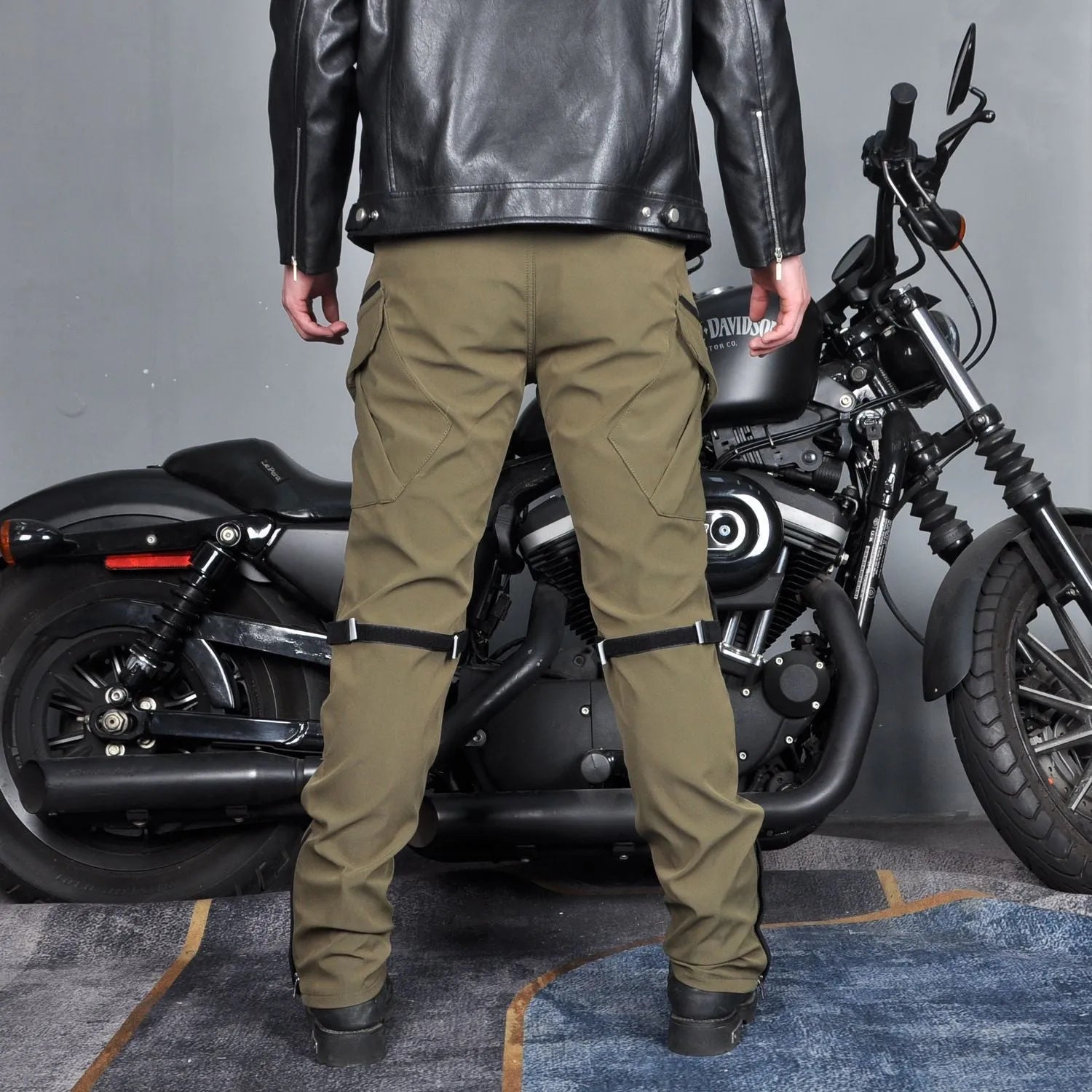 Men's waterproof black motorcycle cycling pants with detachable belt and protective knee pads on a mannequin.