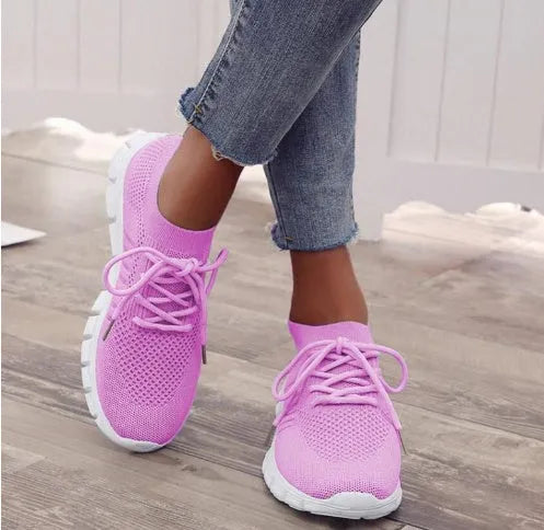 Women's high-cut lace-up sneaker in a choice of colours, showing breathable upper and flat rubber sole.