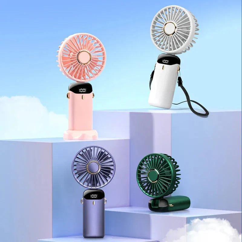 Blue portable electric fan folded at 190-degree angle showing handheld grip, desk base, and neck lanyard attachment
