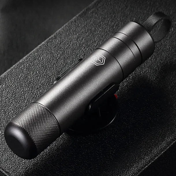 Gun grey aluminium alloy automobile safety hammer with steel impact head, shown with test glass and rubber mount.