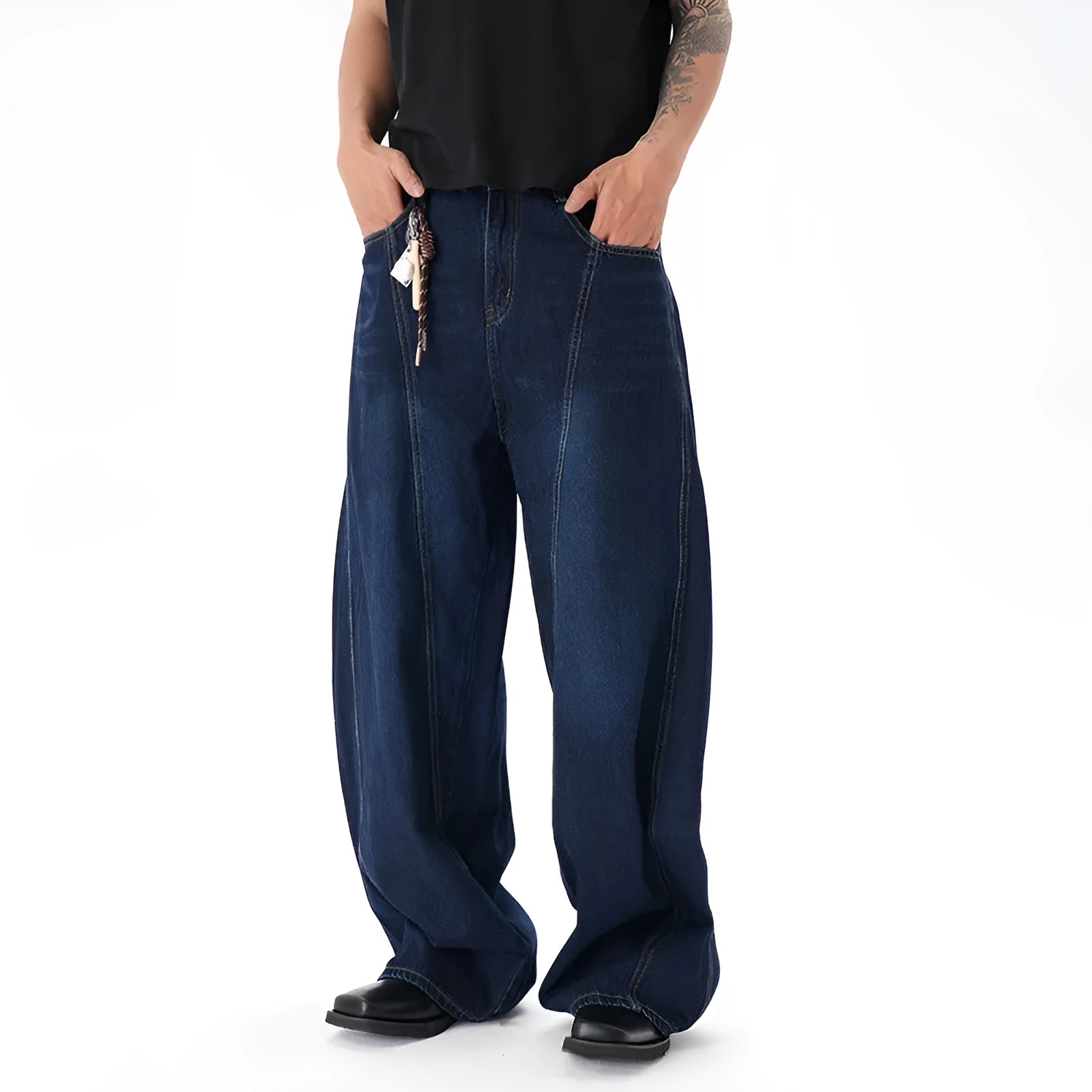 Dark blue washed distressed wide leg machete jeans showing fading and whiskering details