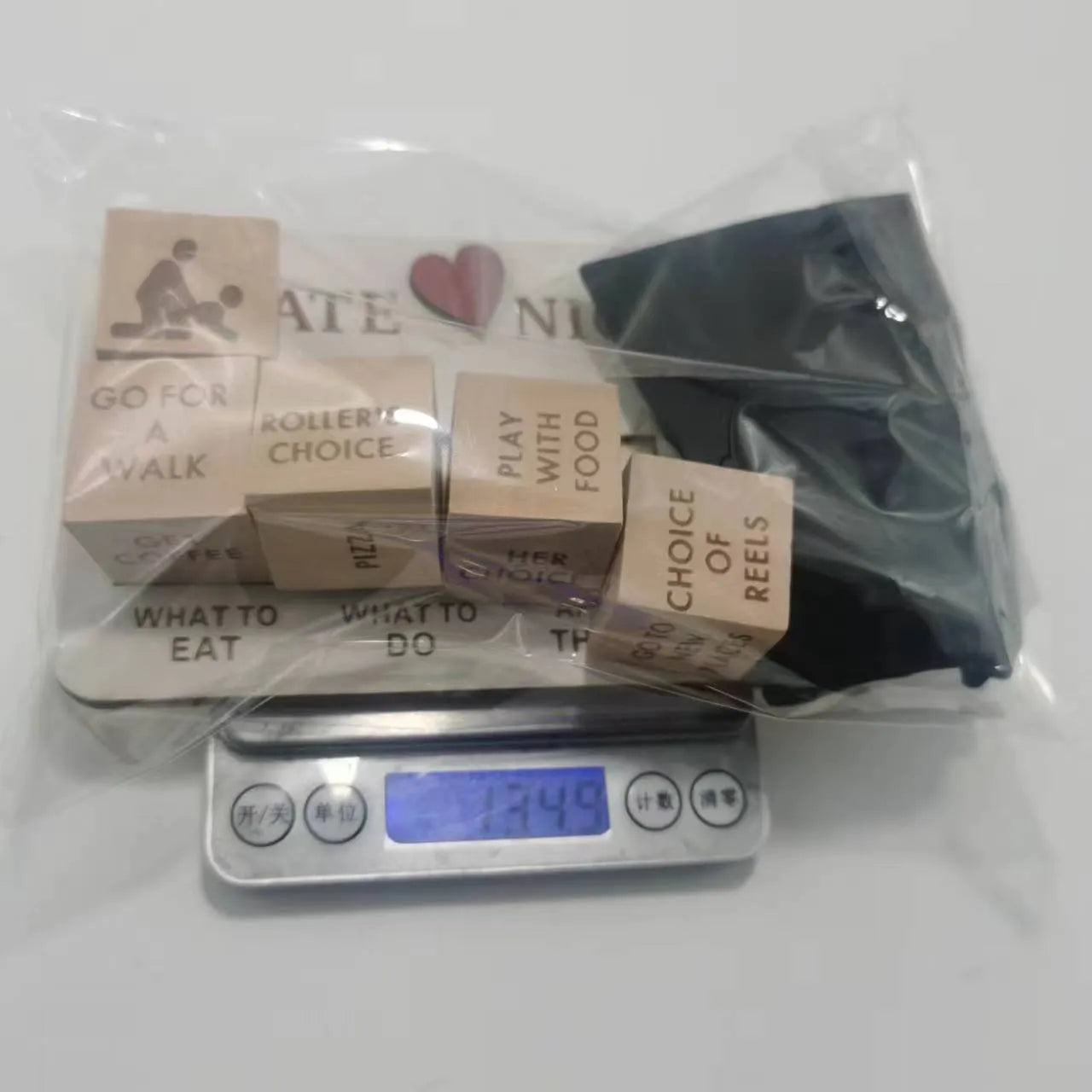 Wooden date night dice game set showing five dice, a rectangular wooden board, and a black fabric storage bag.