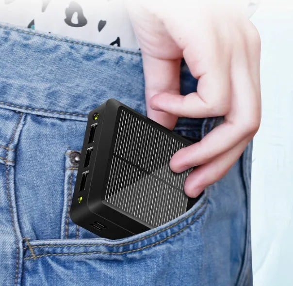 Small portable solar power bank in white plastic case with solar panel on front, 80x80x28mm
