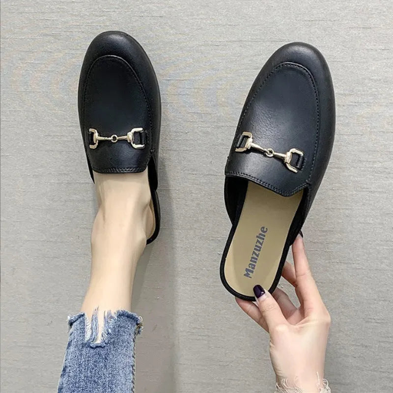 Women's PVC closed toe half slippers shown in milky white colour with a double buckle fastener.