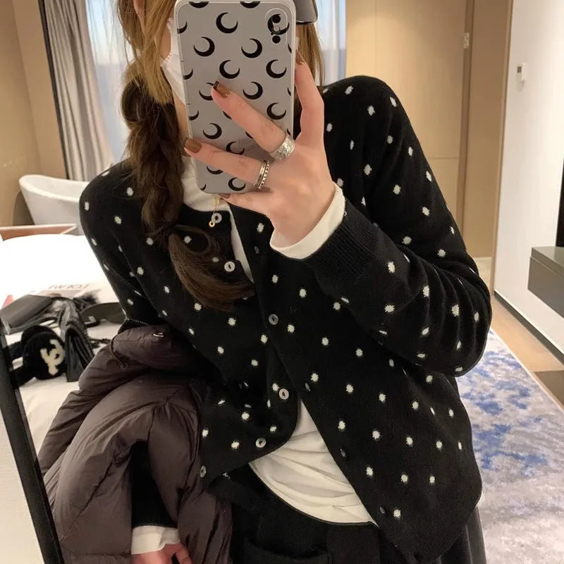 Women's loose grey knitted cardigan with crocheted dot flowers, long sleeves.