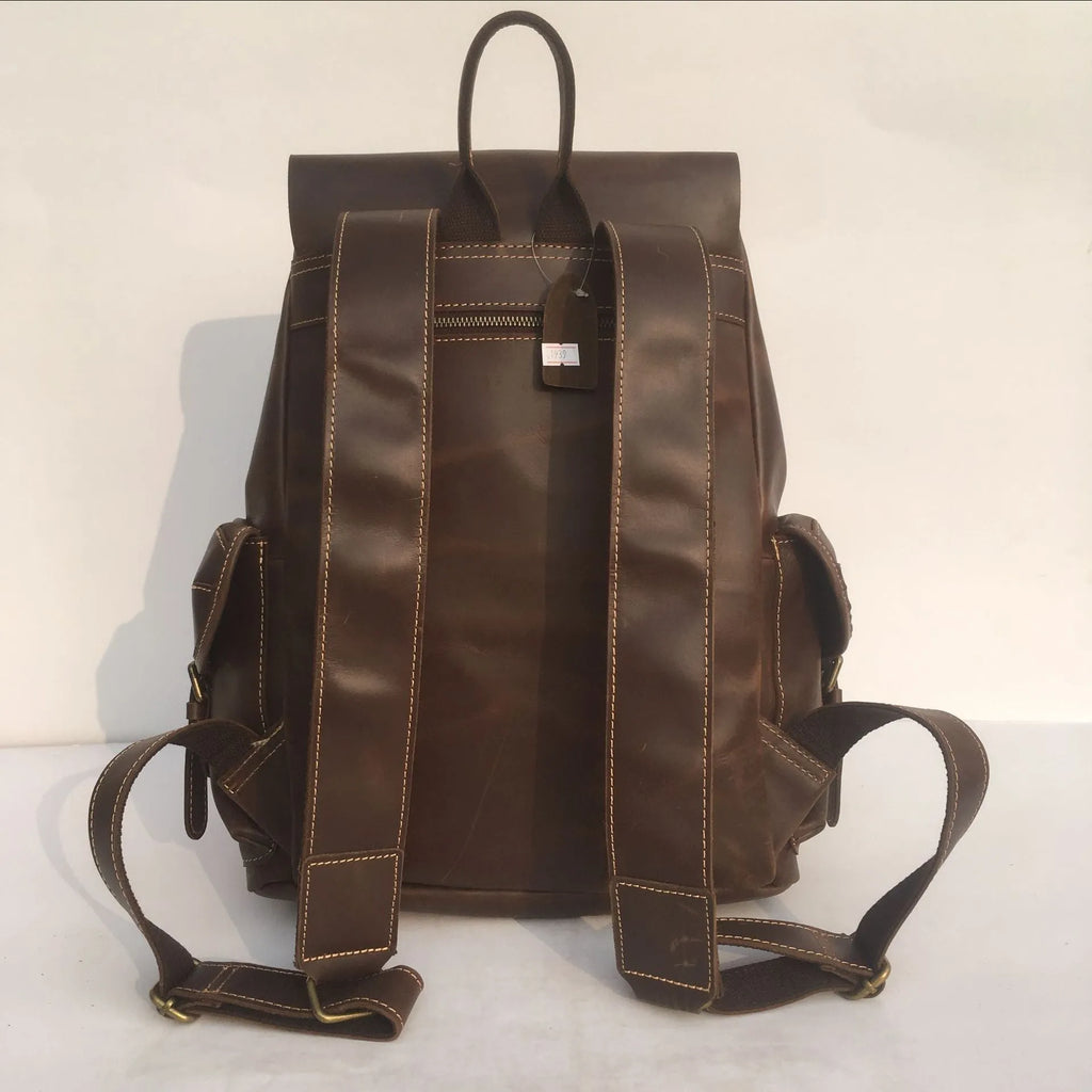 Brown men's leather backpack with an air pillow belt on the straps.