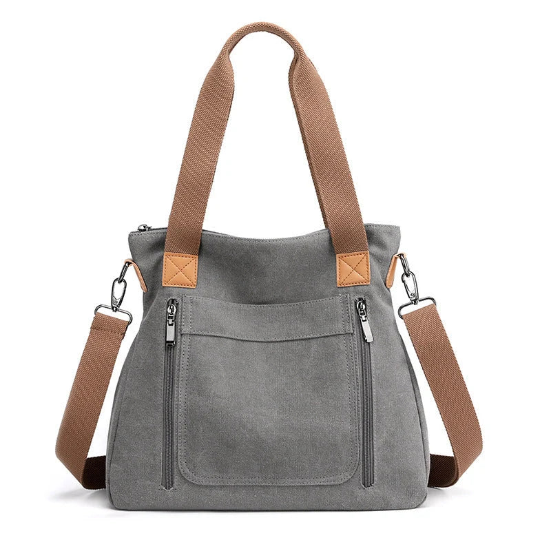 Women's canvas shoulder bag in multiple colours, showcasing spacious interior and zipper closure.