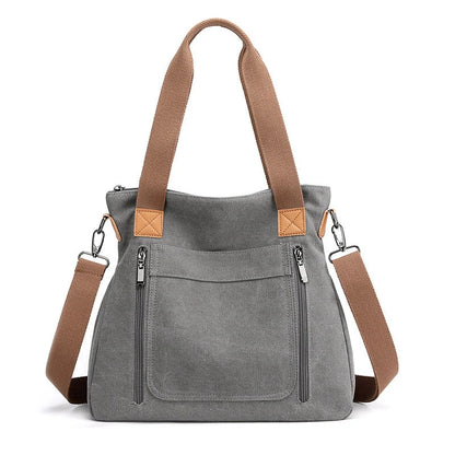 Women's canvas shoulder bag in multiple colours, showcasing spacious interior and zipper closure.