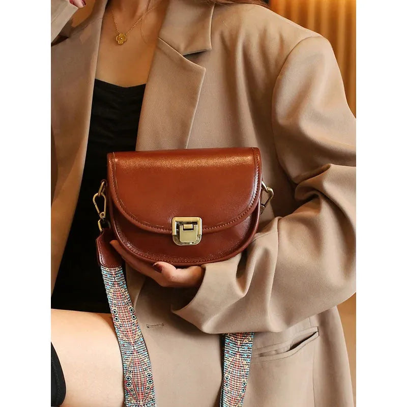 Vegetable tanned top layer cowhide half moon shoulder bag with lock detail, black colour, sandwich pocket, double straps