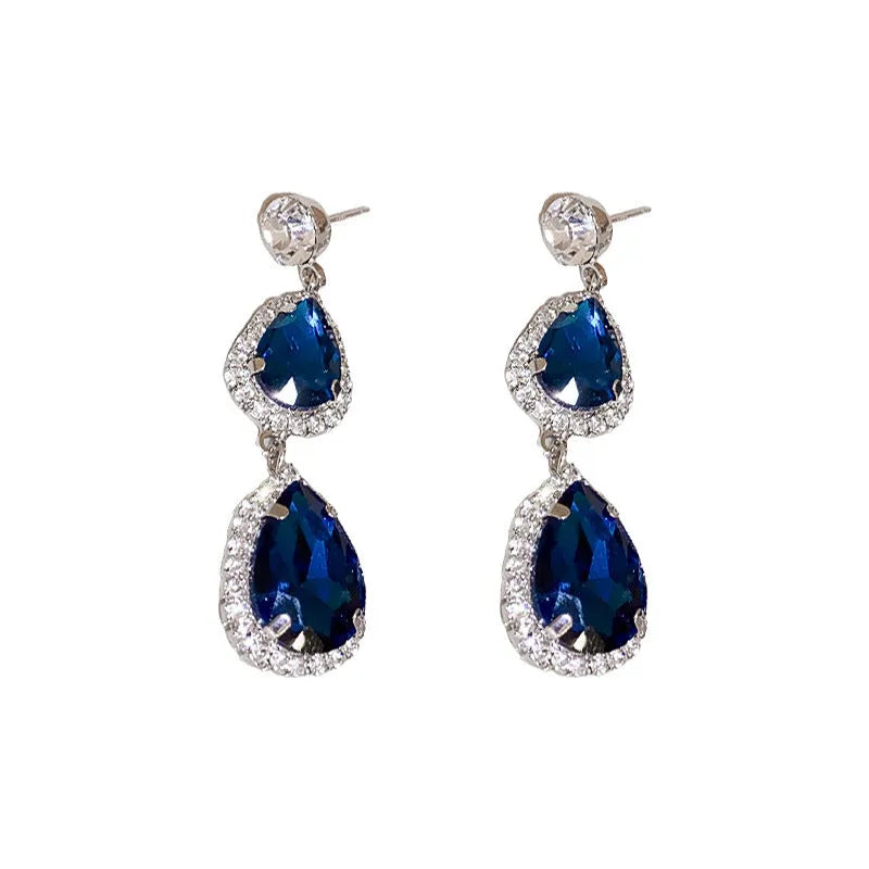 Silver needle water drop earrings and necklace set with blue zircon pendants and love heart bell pattern on white background