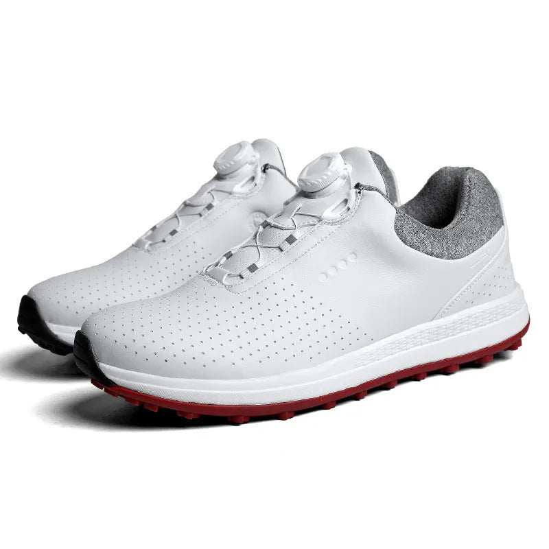 Men's low-top white golf sneakers with breathable hollow-out sole on grass.