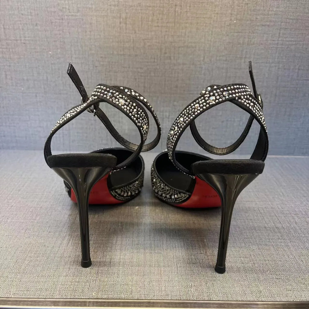 Women's black hollow stiletto heel pump shoe with pointed toe and red sole on a white background.