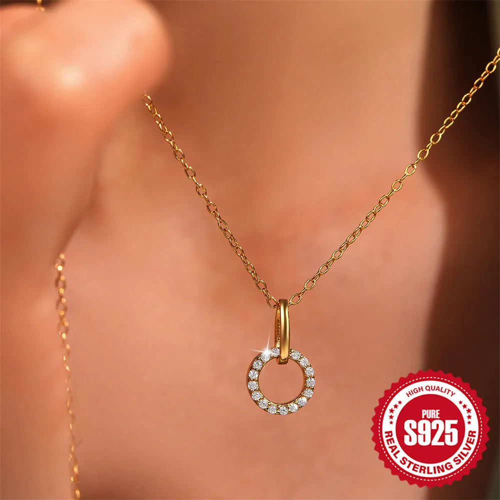 Gold geometric pendant necklace on a model, showing the interlocking design and adjustable clavicle chain.