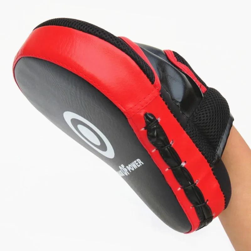 Red and black martial arts hand target kick pad for boxing and taekwondo training drills.