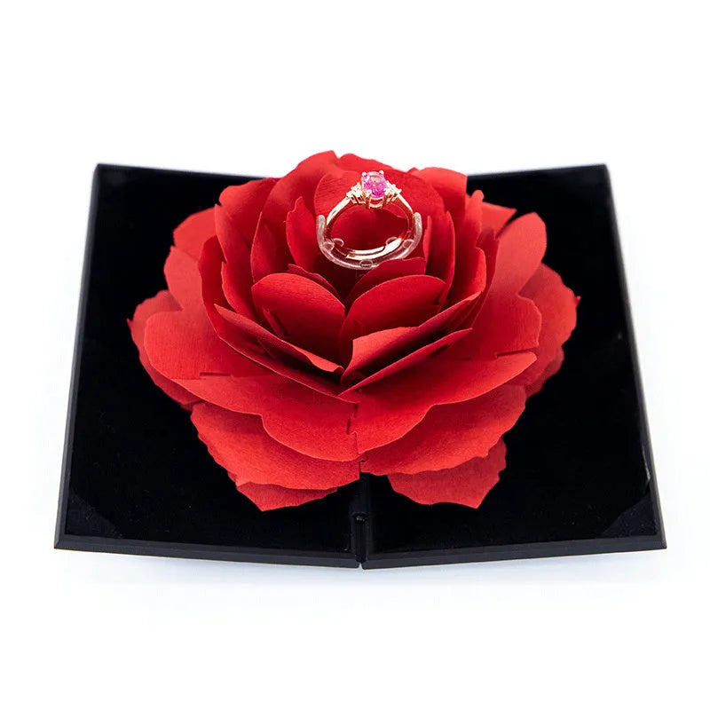Red 3D heart-shaped rotating ring box with a rose flower decoration, open to show ring placement.
