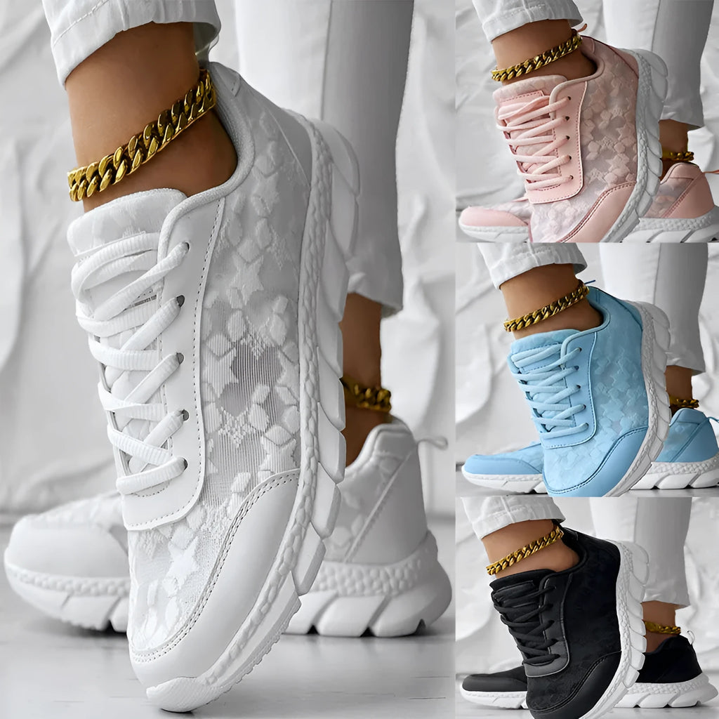 Women's white canvas casual running shoes with soft flat soles on a light background.