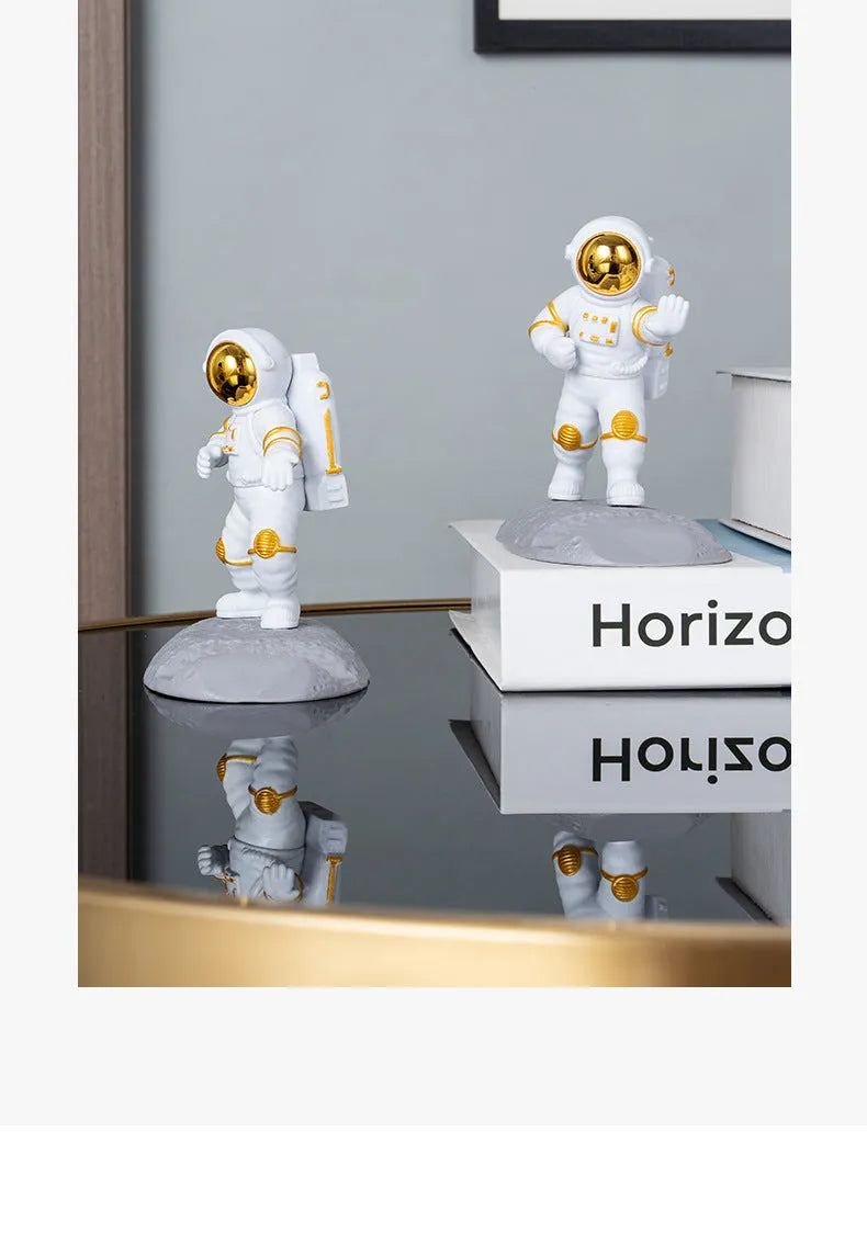 Plastic astronaut decoration mobile phone holder in blue colour on a desk