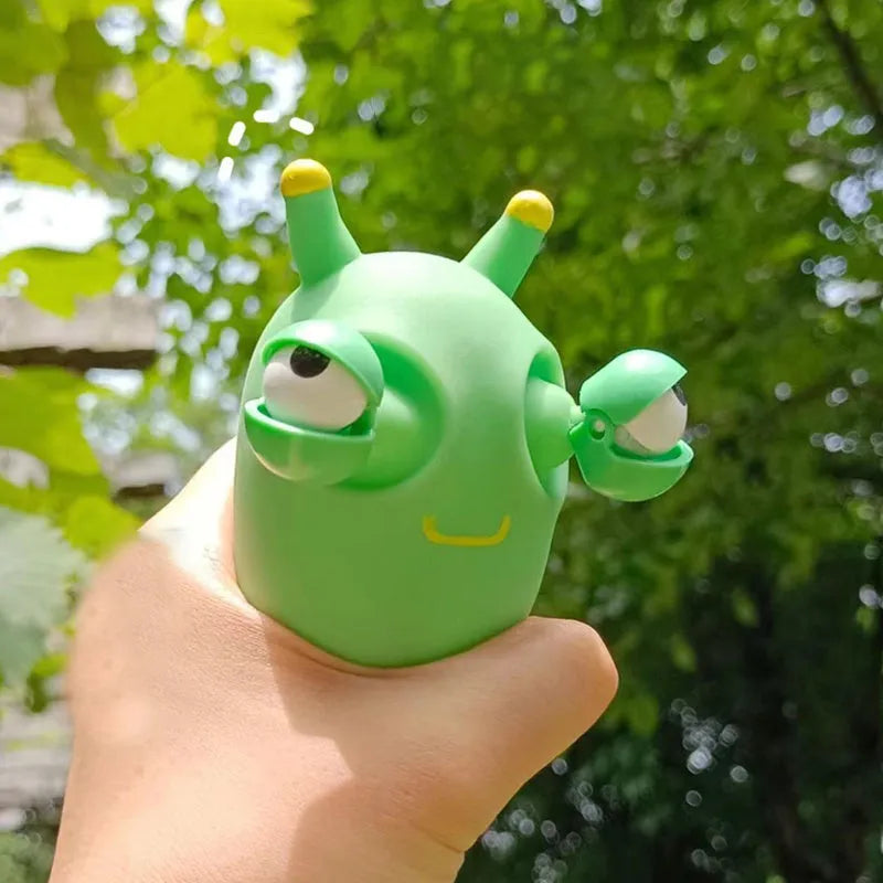 Green caterpillar squeaky toy with eye-popping feature, 8cm long PVC decomposition prank item