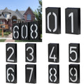 Solar powered house number light with LED illumination mounted on exterior wall