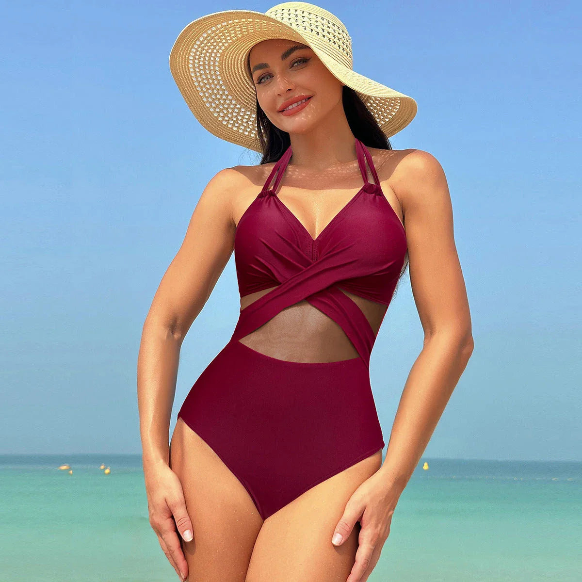 Stylish one-piece swimsuit with cross-strap design and mesh panels, available in a variety of vibrant colors