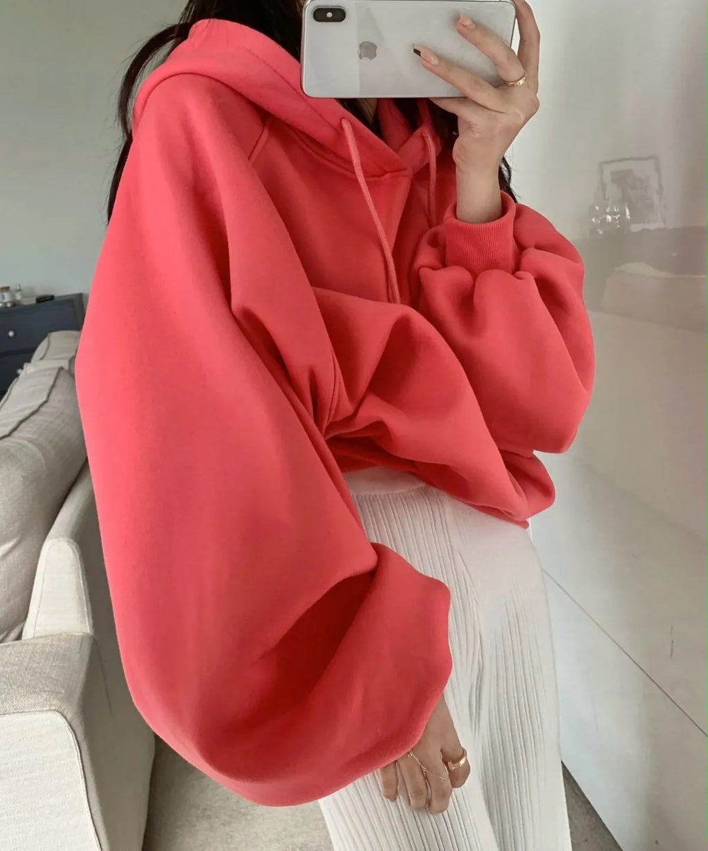 Watermelon red women's loose mulberry silk hooded sweater on a hanger.