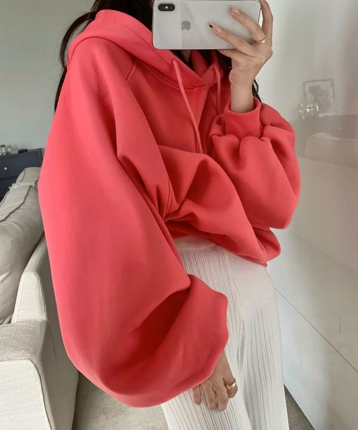 Watermelon red women's loose mulberry silk hooded sweater on a hanger.