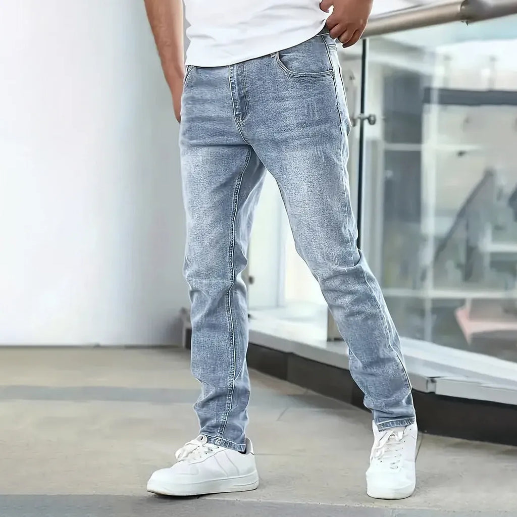 Men's black stretch jeans with straight leg and skinny opening, laid flat.