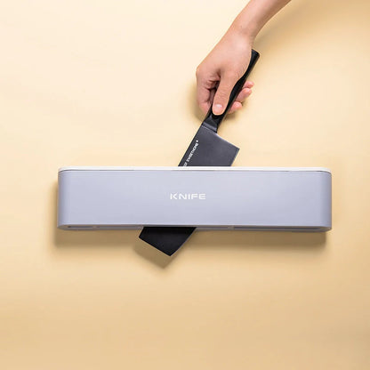 Wall-mounted kitchen knife holder in grey, pink, and light blue