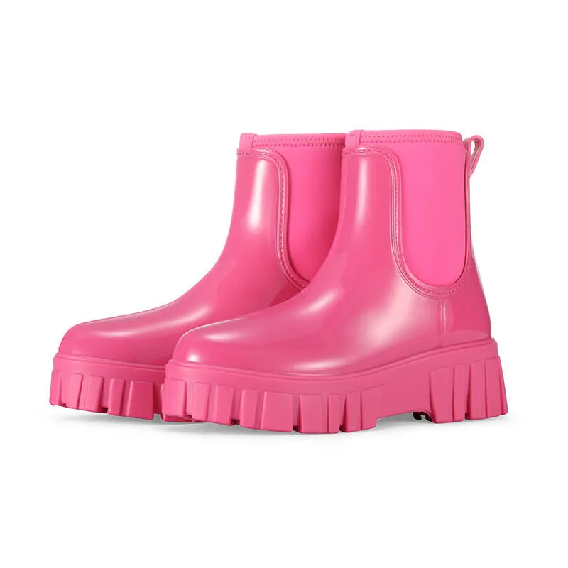 PVC low tube rain boot in solid colour with flat heel and non-slip sole.