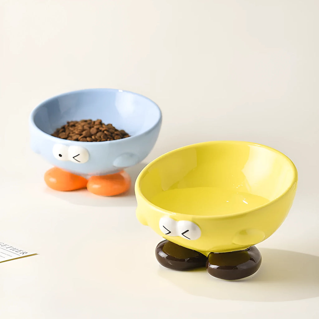 Blue tall ceramic pet food bowl with oblique shape and a silicone non-slip ring on the base.